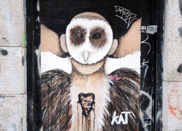poster of anthromorphic creature with animal mask on, owl mask, with bleeding heart on its chest, and furry feather like coat