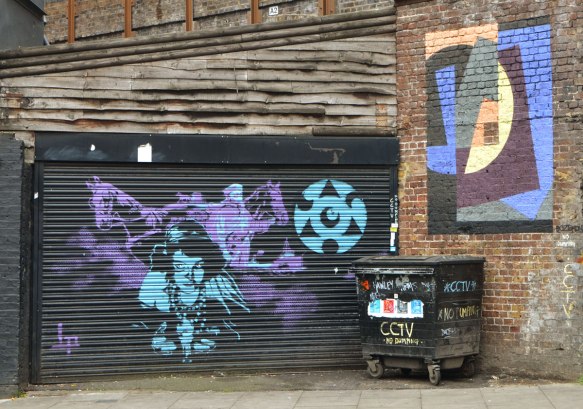 painting on a black metal garage door of a blue woman and a purple horse 