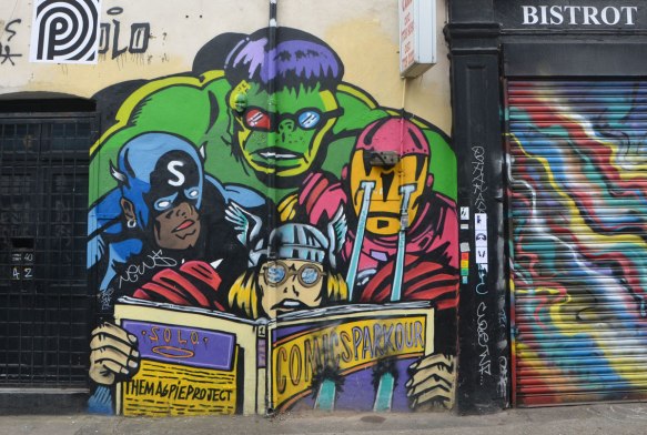 a group of comic book heros is reading a comic book together, The Hulk, a man with laser vision, Thor, and a man with a blue costume and an S on his hood. 