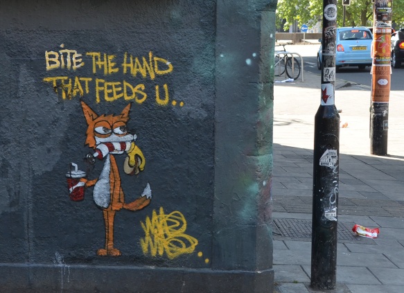 a graffiti fox, standing on two legs, with words, bite the hand that feeds you.
