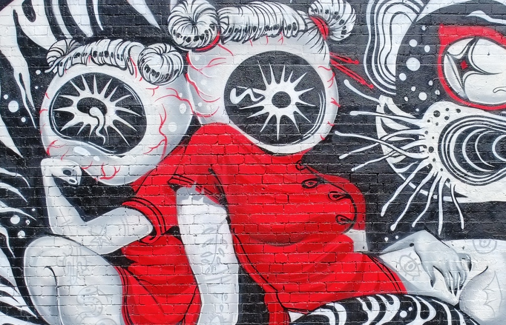part of a mural by Lauren YS, two women in Asian red dresses with hair in two buns