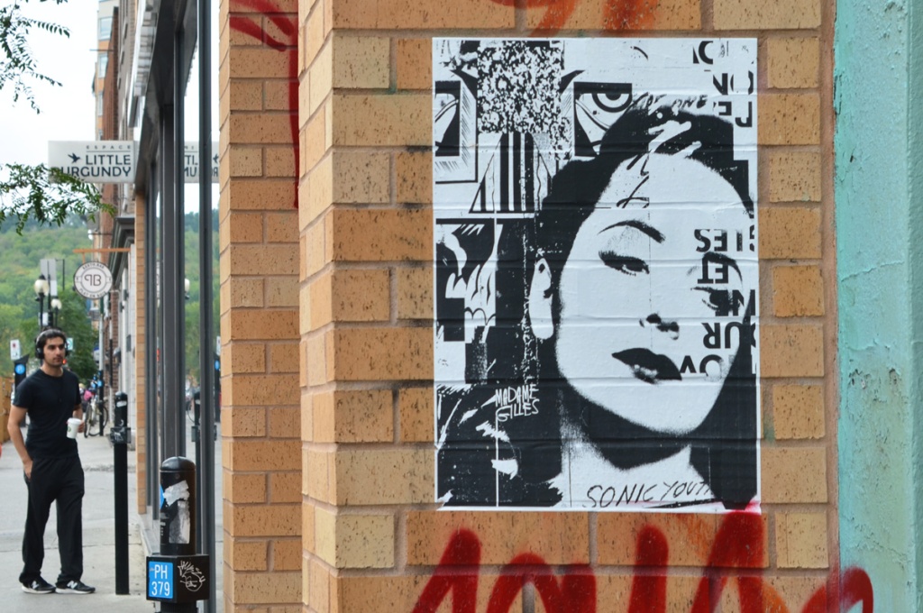 black and white paper pasteup graffiti by Madame Gilles, womans face is predominant feature