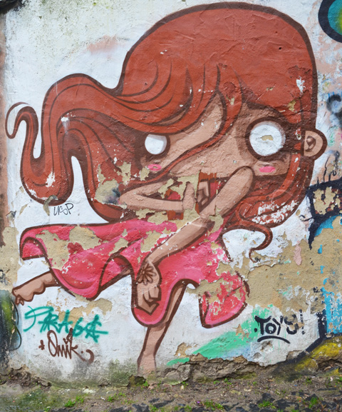 street art painting of a young woman with large head, white eyes, long reddish hair, pink dress and bare feet, by omik a k a Mikael Guedes
