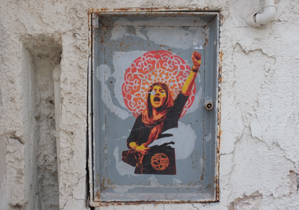 stencil , woman with one fist raised, paste up
