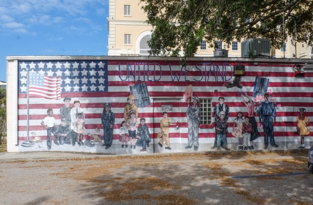 patriotic mural, american flag, words united we stand, kids, firemen, police, medical people, community