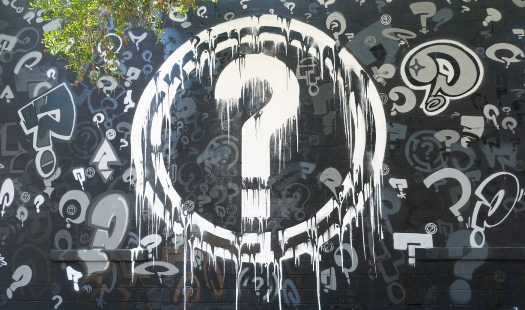 mural with a large white question mark in a circle, surrounded by hundreds of smaller question marks