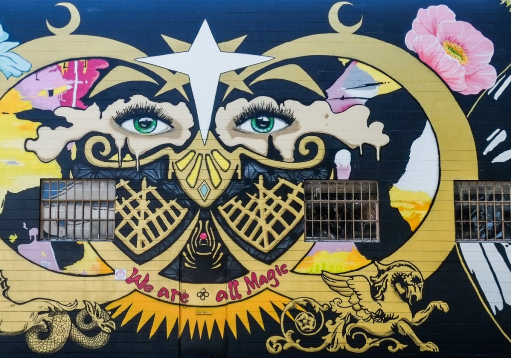 close up of mural by sarah sheppard, eyes, butterfly, text that says we are all magic