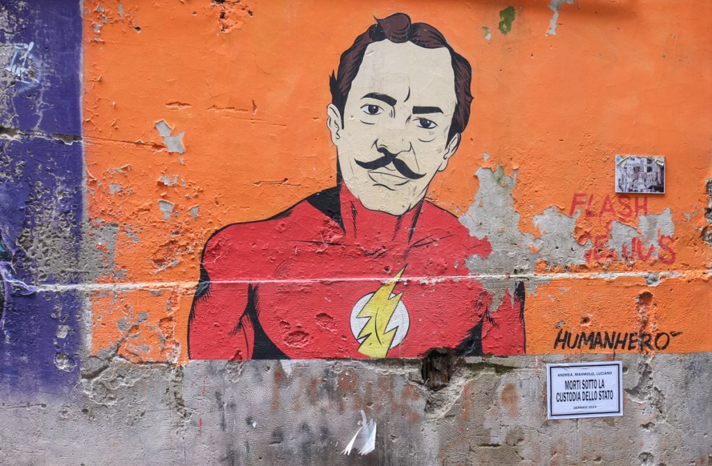 portrait of a man with a mustache, he's wearing red top of the Flash outfit, on orange background