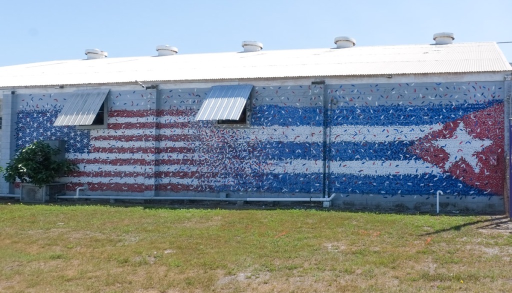 mural, two flags, american on the left and cuban on the right, that merge in the middle