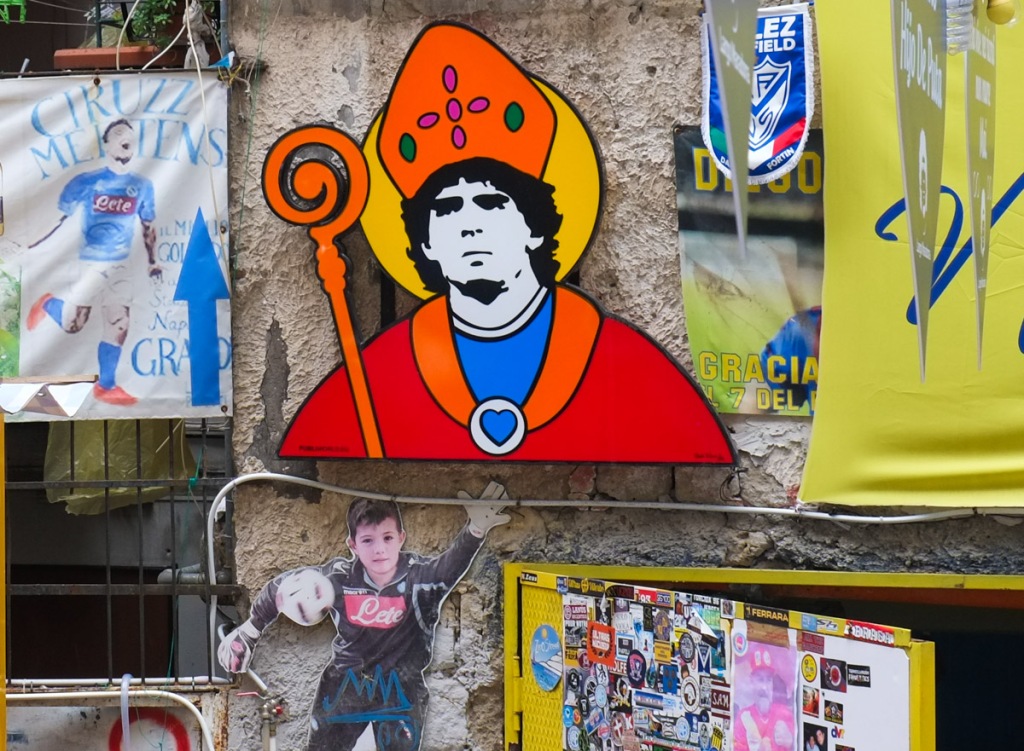 diego maradona themed street art in quatieri spagnoli in naples napoli, maradona dressed as a bishop with staff and funny hat, bishops mitre