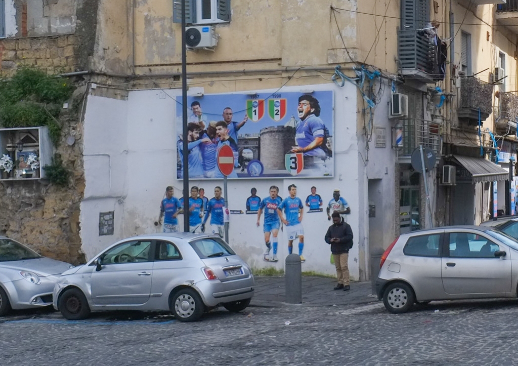 diego maradona themed street art in quatieri spagnoli in naples napoli, many life sized football players on a wall